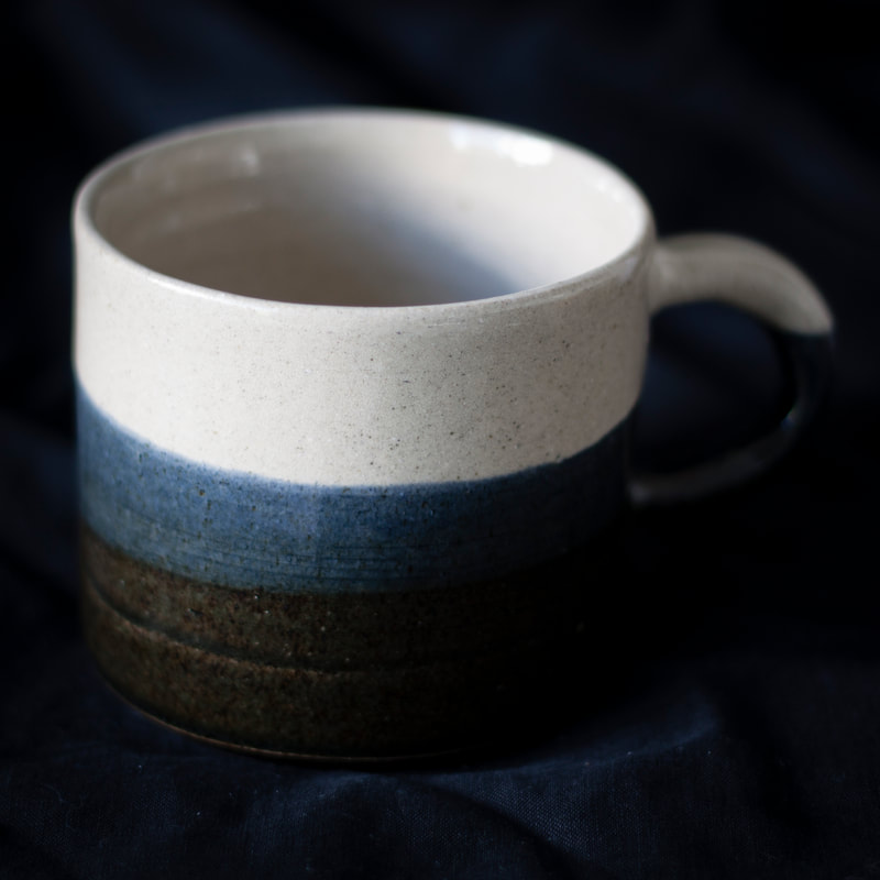 Artefact:Mug Background:Black Clay:IronStone Collective:Single Glaze:ClearGloss Glaze:SchefflinBlue Orientation:Perspective